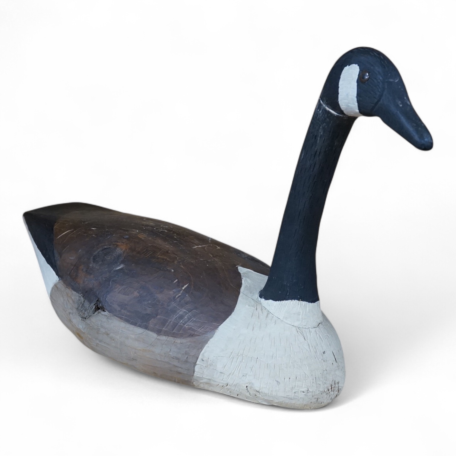 A Canada Goose carved and painted wood decoy, 56cm wide